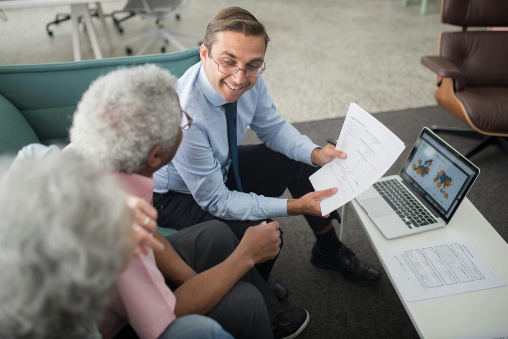 Family in the USA applying for Section 8 and LIHEAP USA benefits on a laptop, with utility bills and housing forms nearby.