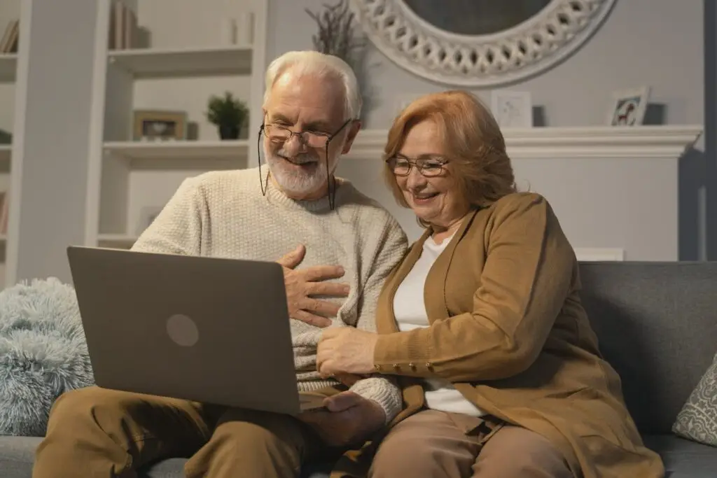 Elderly couple reviewing retirement documents with a financial advisor in Italy
